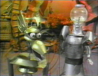 Crow and Servo (with popcorn in his head), from episode K01